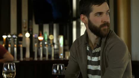 attractive couple talking at the bar