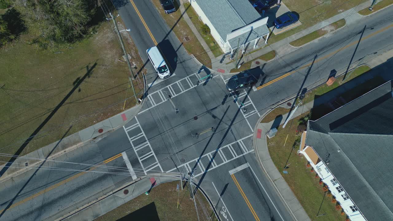 Vehicles Slowing Down And Yielding At Intersection In Daytime. aerial topdown shot, slow motion