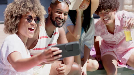 taking selfie, group of diverse friends smiling and enjoying outdoor hangout