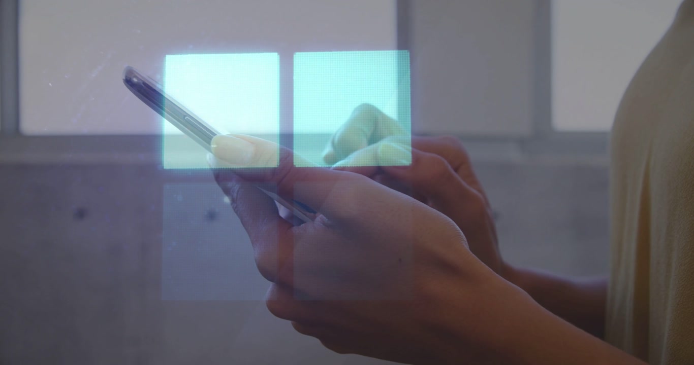 Vertical video: Tapping hands holding phone to interact with blue UI near cabinets, mustard top