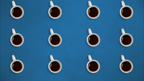 vista superior. detener el movimiento. tazas de café girando y llenando con café. en fondo azul. video de bucle. concepto de tiempo café, energía, publicidad, energía, sistemas. taza de café 4k imágenes de stock