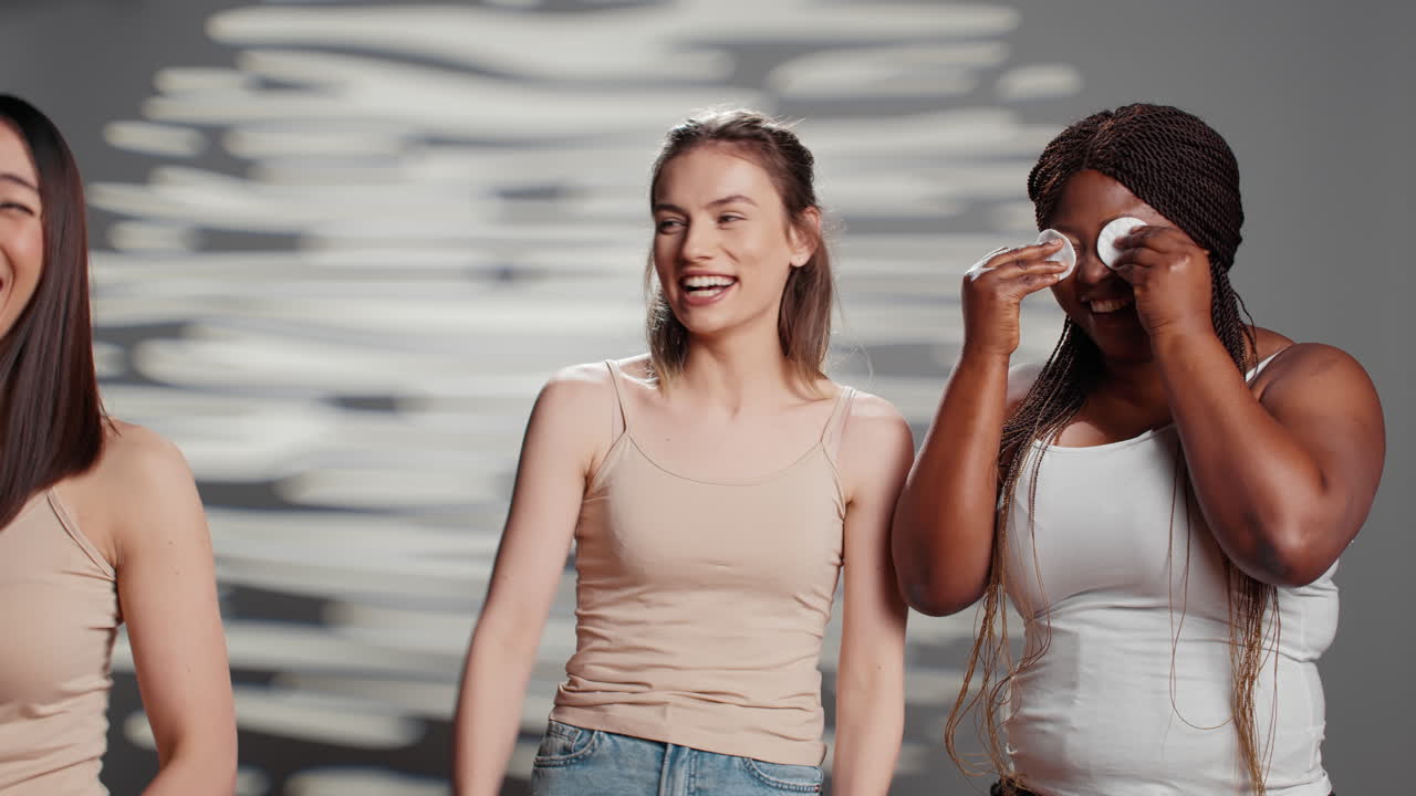 Multiethnic women doing skincare with cotton pads