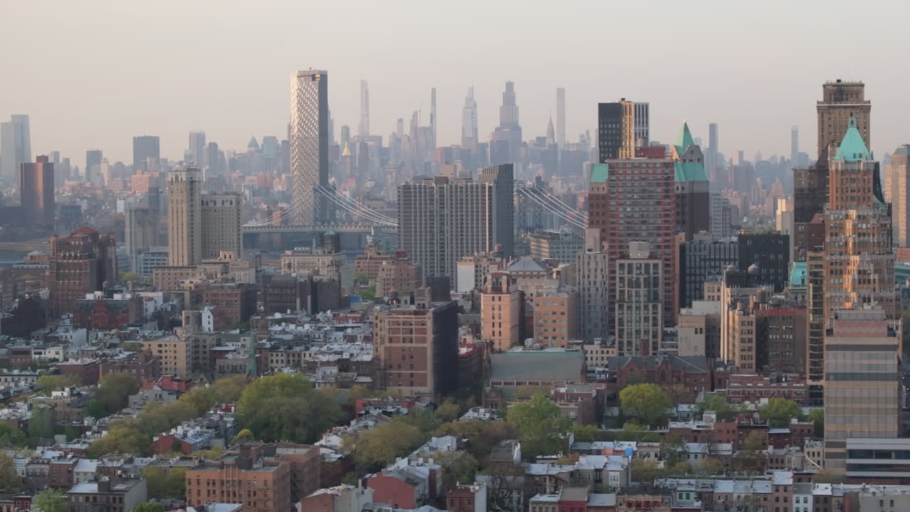 Aerial view of downtown Brooklyn on an overcast day with midtown Manhattan in the background.