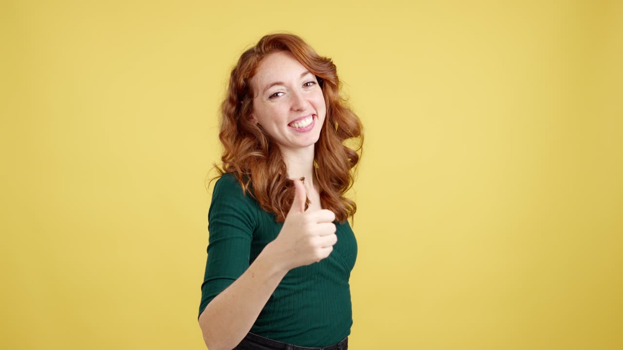 Smiling Redhead Woman Giving Thumbs Up