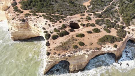 benagil cave, atlantic sea waves washing on the cliffs, lagoa, algarve, portugal