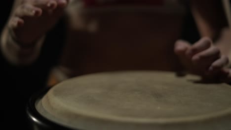 group of a professional dancers are practicing capoeira in darkness against a spotlight on a black background of studio. afro-brazilian martial art that combine elements of dance.