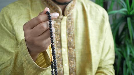 man holding prayer beads