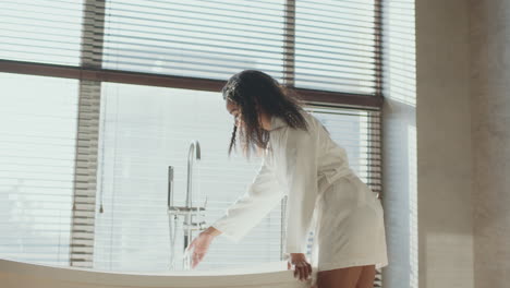 woman in a bathrobe in a luxury bathroom