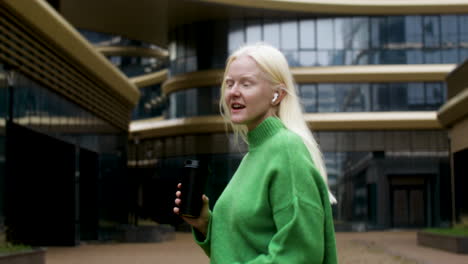 happy woman holding coffee cup outdoors