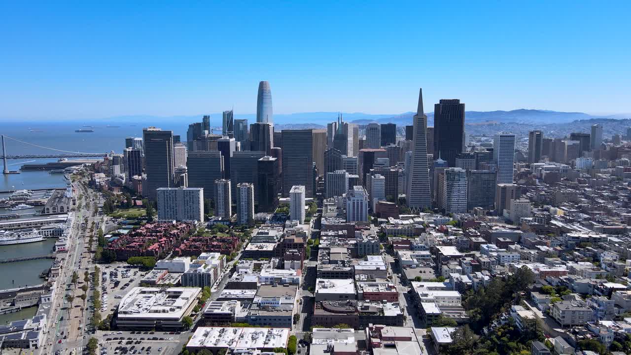 A stunning drone view of San Francisco's bustling downtown, featuring iconic skyscrapers and the bay