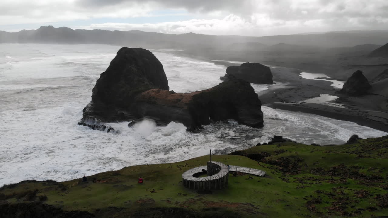 Scenic coastal landscape with rock formations at Piha Beach, New Zealand