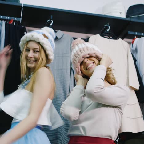 two friends having fun in a clothing store