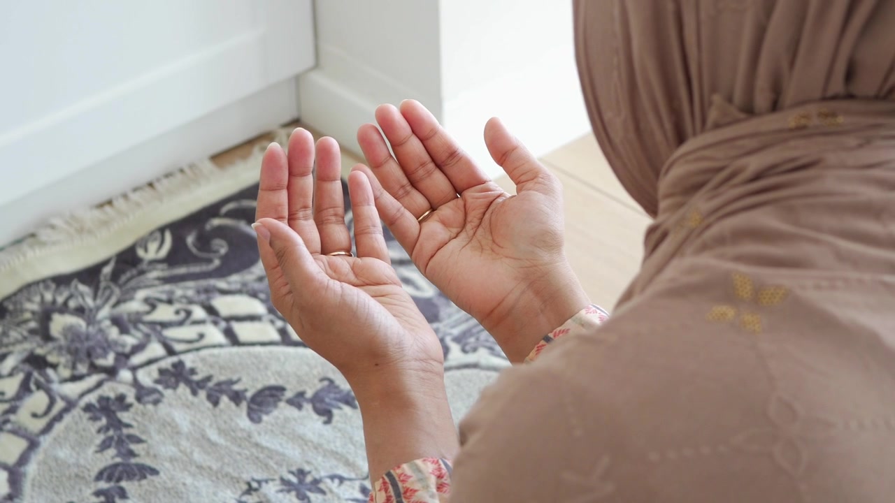 Muslim Woman Praying with Hands Raised in Supplication