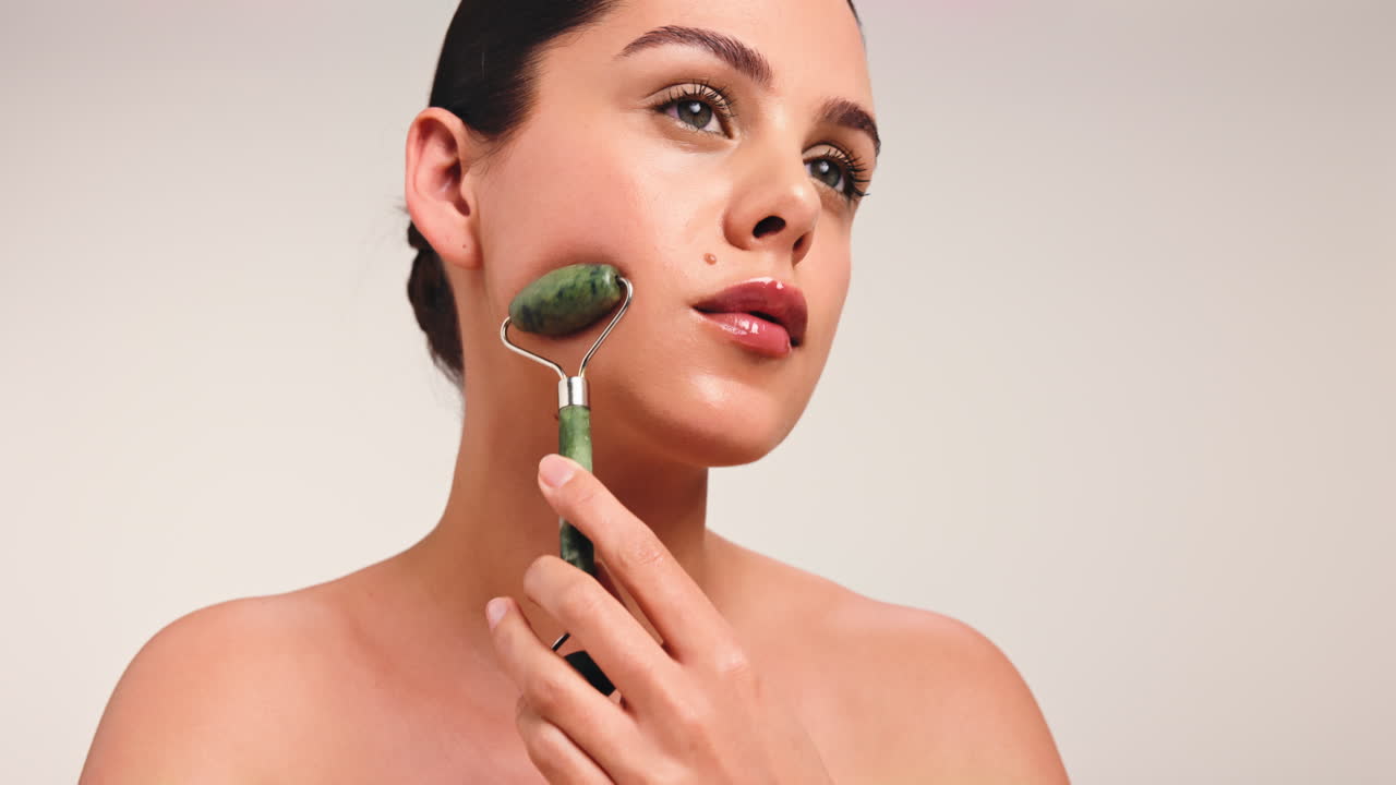Woman using a jade roller for skincare