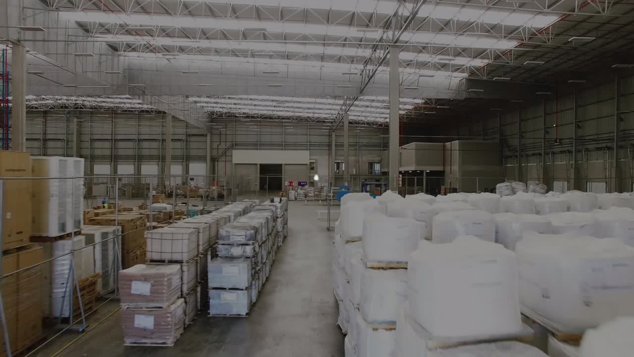 Animation of icons connected with lines, globe over aerial view of warehouse
