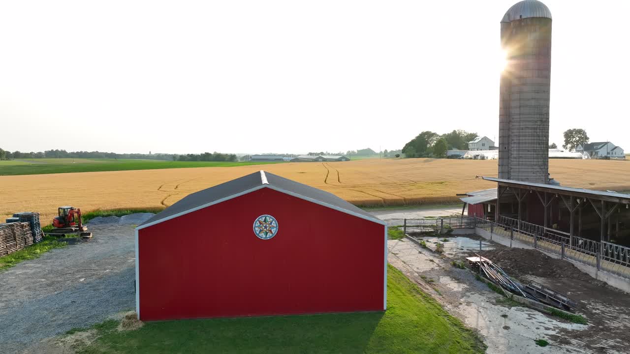 Red barn with Hex sign during beautiful summer sunset