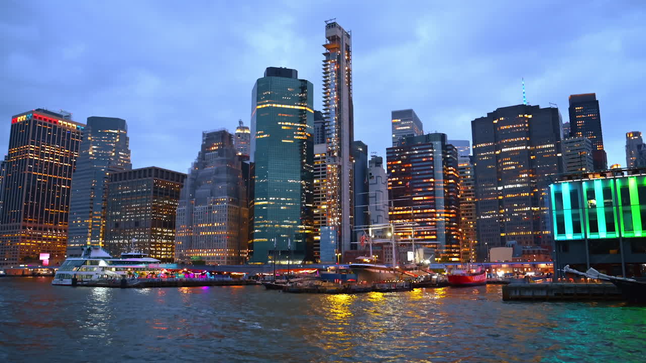 Stunning architecture of modern New York from the riverscape. Travel by the East River at dusk time