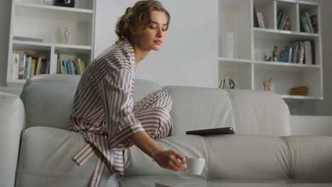 businesswoman working home morning in living room. girl stretch yawning on sofa