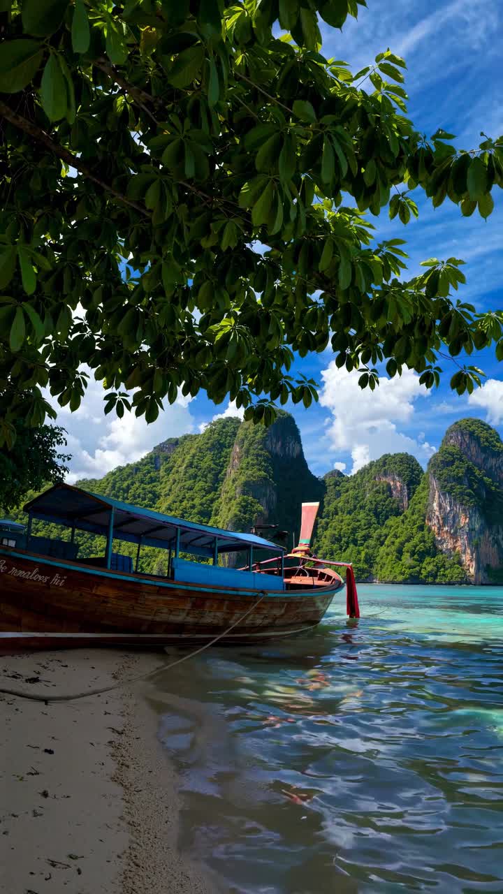 Scenic video still of a long-tail boat on a tropical beach, captured from a low angle