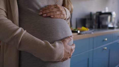 Close-up-of-pregnant-woman-touching-the-belly