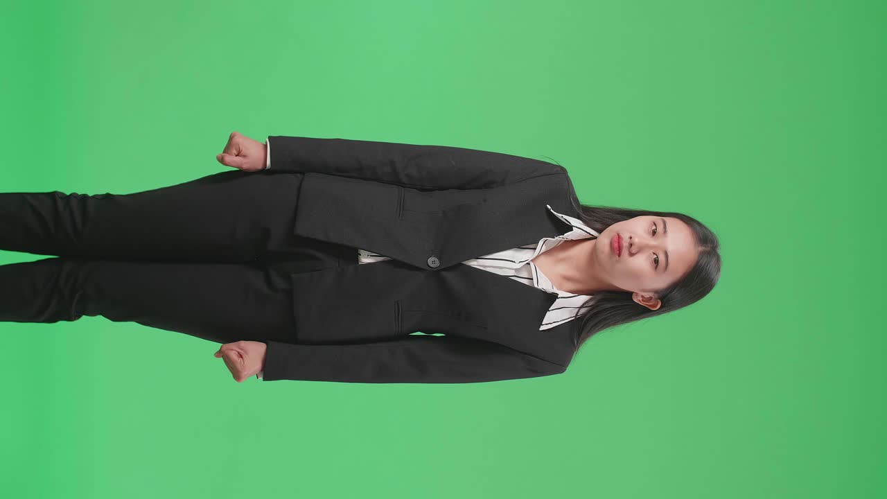 A Terrible Asian Business Woman Looking At Camera In The Green Screen Studio