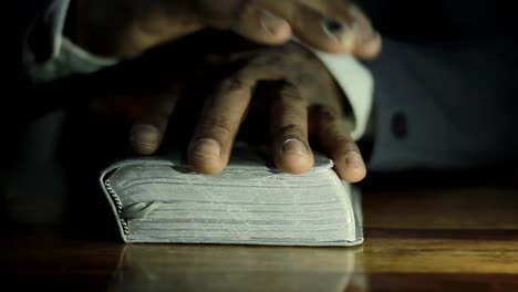 praying-to-god-with-bible-on-table-with-people-stock-video-stock-footage