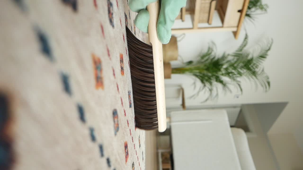 Cleaning a carpet with a broom