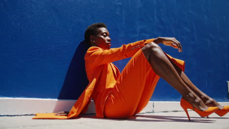 vibrant fashion portrait: woman in orange suit