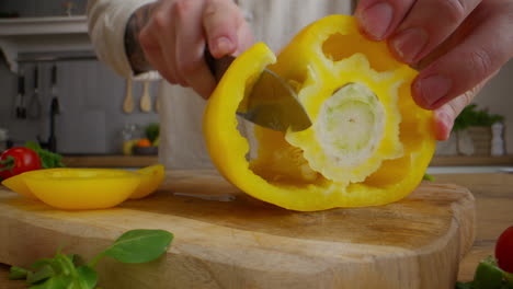 cutting a yellow bell pepper