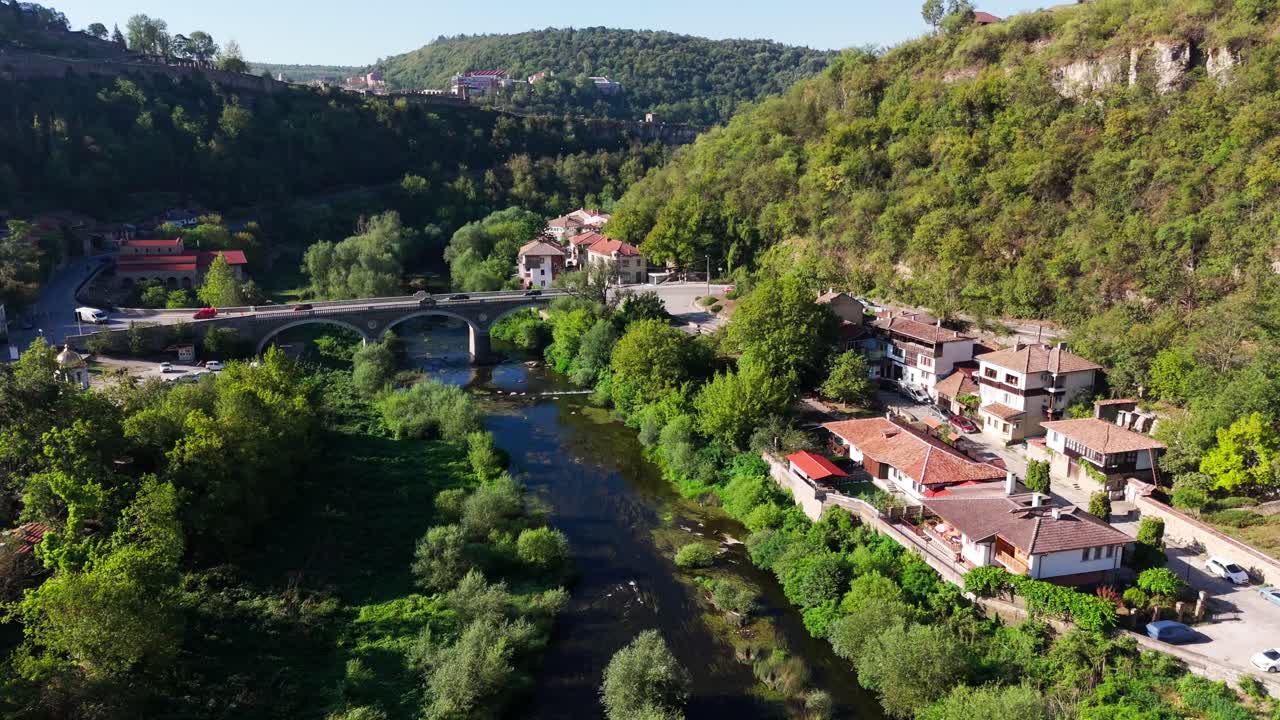 Scenic follow shot tracing the winding river encircling Tsaravets fortress, showcasing nature and medieval history in Veliko Turnovo.