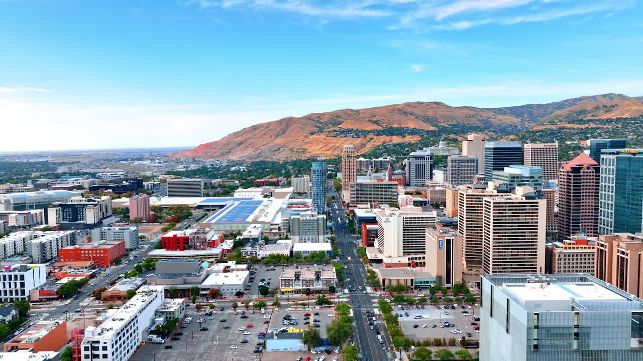 Salt Lake Sity USA, 14 August 2025: Salt Lake City scenery at daytime. Footage over the wide-lane road crossing the cityscape. Mountains at backdrop