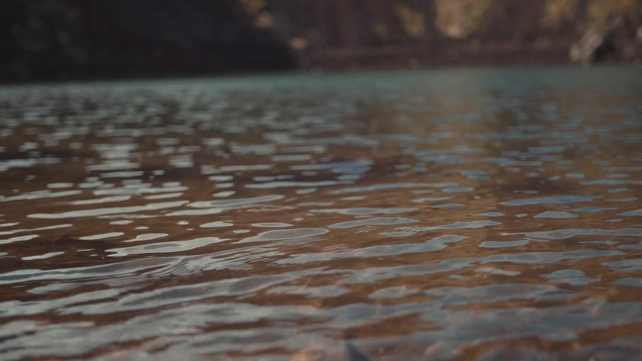 Tranquil Lake Water Surface with Small Ripples and Reflections