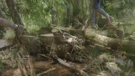 Happy-african-american-couple-hiking-and-camping-together-in-forest,-slow-motion