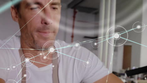 animation of network of connections with icons over caucasian man using smartphone by motorbike