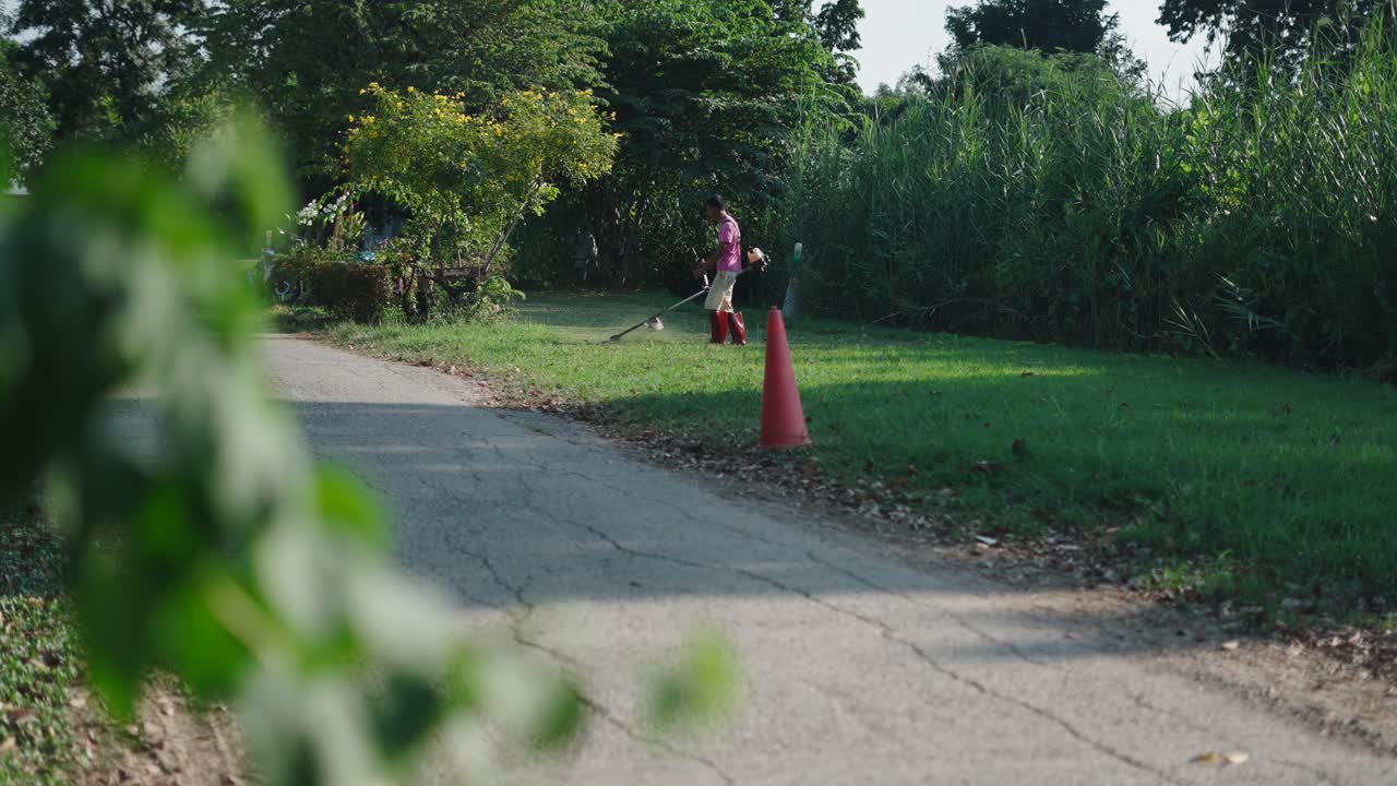 Man mowing grass in a park