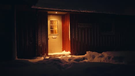 illuminated door of a cottage at night