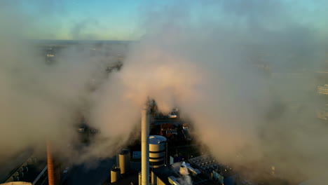 Aerial-view-of-fly-though-smoke-emitted-by-chimney-polluting-urban-landscape