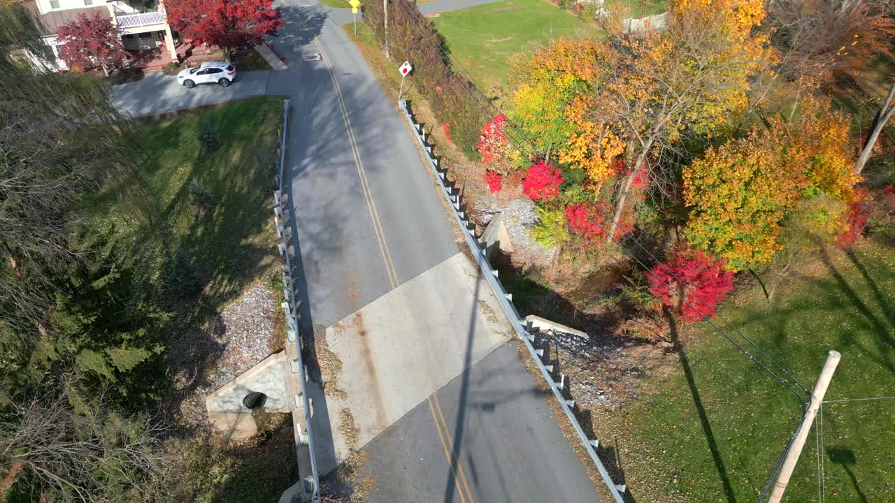 Aerial drone video of a bridge during fall and autumn colors