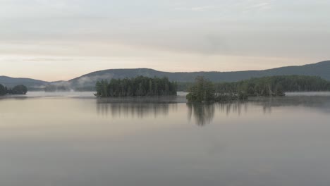 aerial pulling back over calm water prong pong sunrise