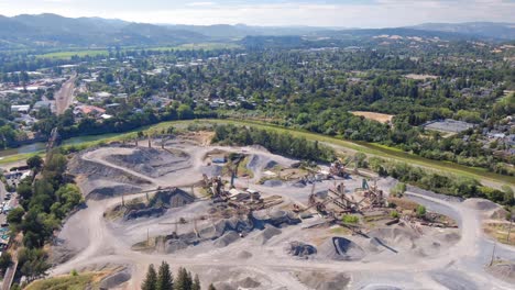 Panoramic-tilt-up-of-an-industrial-concrete-production-plant-near-the-Russo-River-in-Healdsburg,-CA