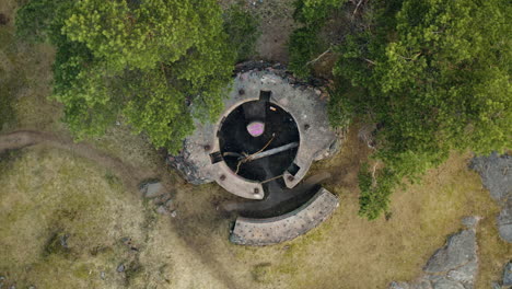 floating high above the remains of a bunker from world war one with a slow spin overhead from a top-down perspective