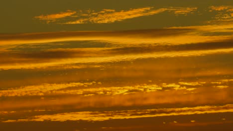 establishing shot of impressive sunset golden hour natural layered clouds in france, europe 4k