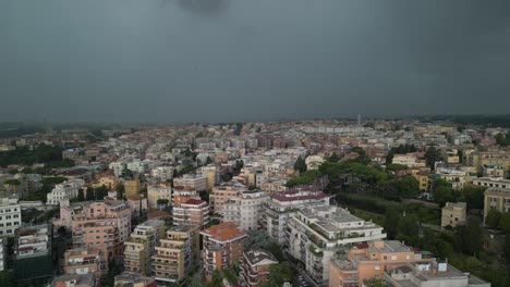 Aerial-drone-tilt-down-shot-of-dark-rain-clouds-over-residential-buildings-in-the-city-of-Rome,-Italy