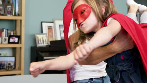 father and daughter pretending to be superhero