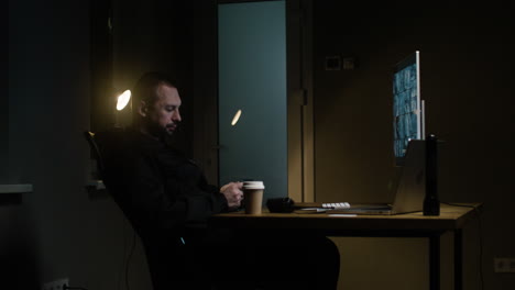 man with smartphone in the hut at night