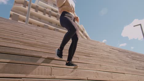 a girl in a tracksuit is running down a flight of stairs in an exercise