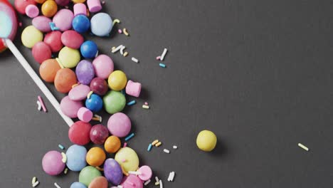 video of colourful lentils and lollipop on grey background