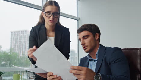 Business-partners-checking-papers-in-office-closeup.-Mad-manager-throw-report