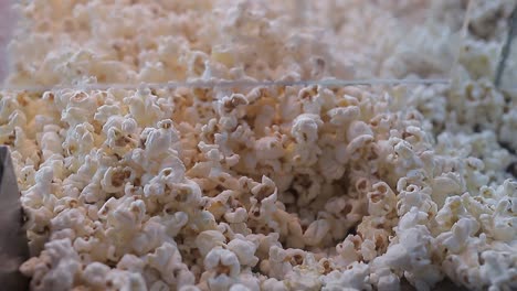 a lot of popcorn pours in. close-up