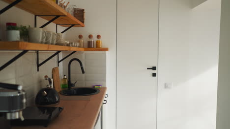 kitchen with utensils in glamping hotel. light room with decorative elements for comfortable stay for tourists. review of accommodation for rent for visitors